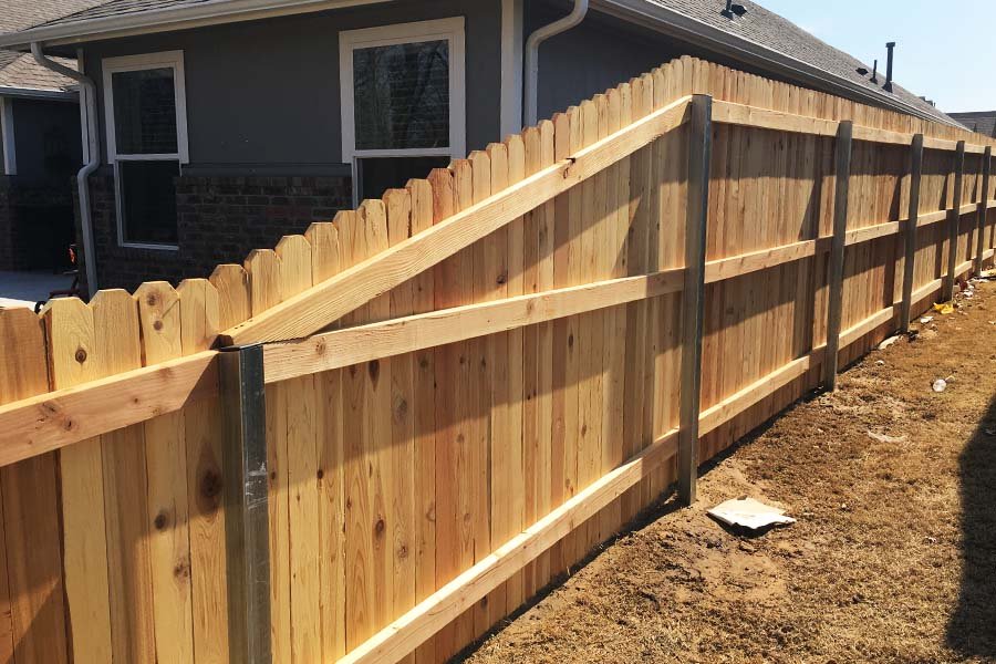 How to Install a Wood Fence With Metal Posts